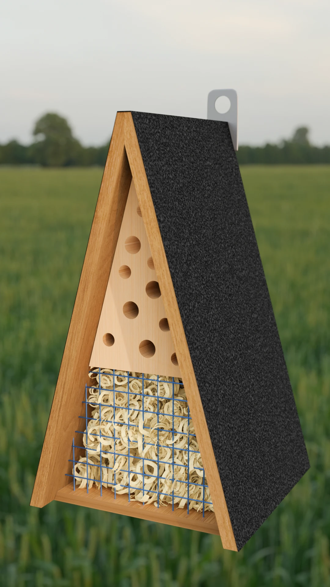 Ein Insektenhotel mit Grünen Pflanzen als unscharfer Hintergrund.